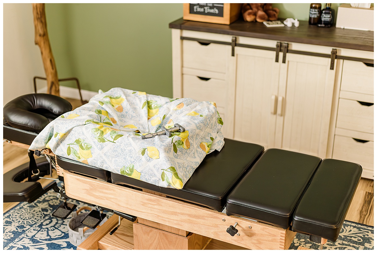 How chiropractic care can support pregnancy. Pictured is a chiropractic table and a pregnancy pillow and also an activator tool.