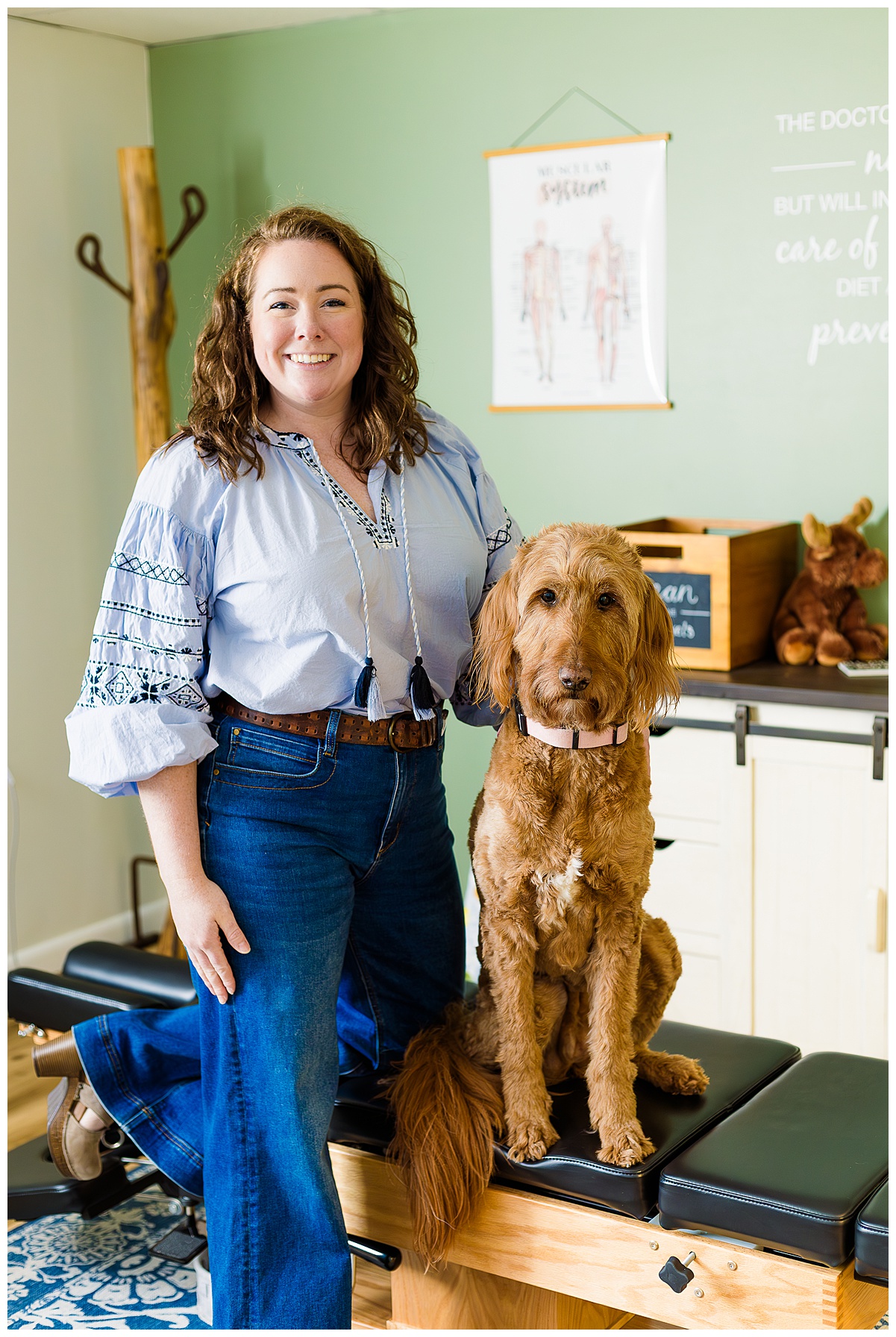 Dr. Kate prenatal chiropractor located in Pittsburgh, PA. She is pictured in her office with her dog who is her office assistant. How chiropractic care can support pregnancy.