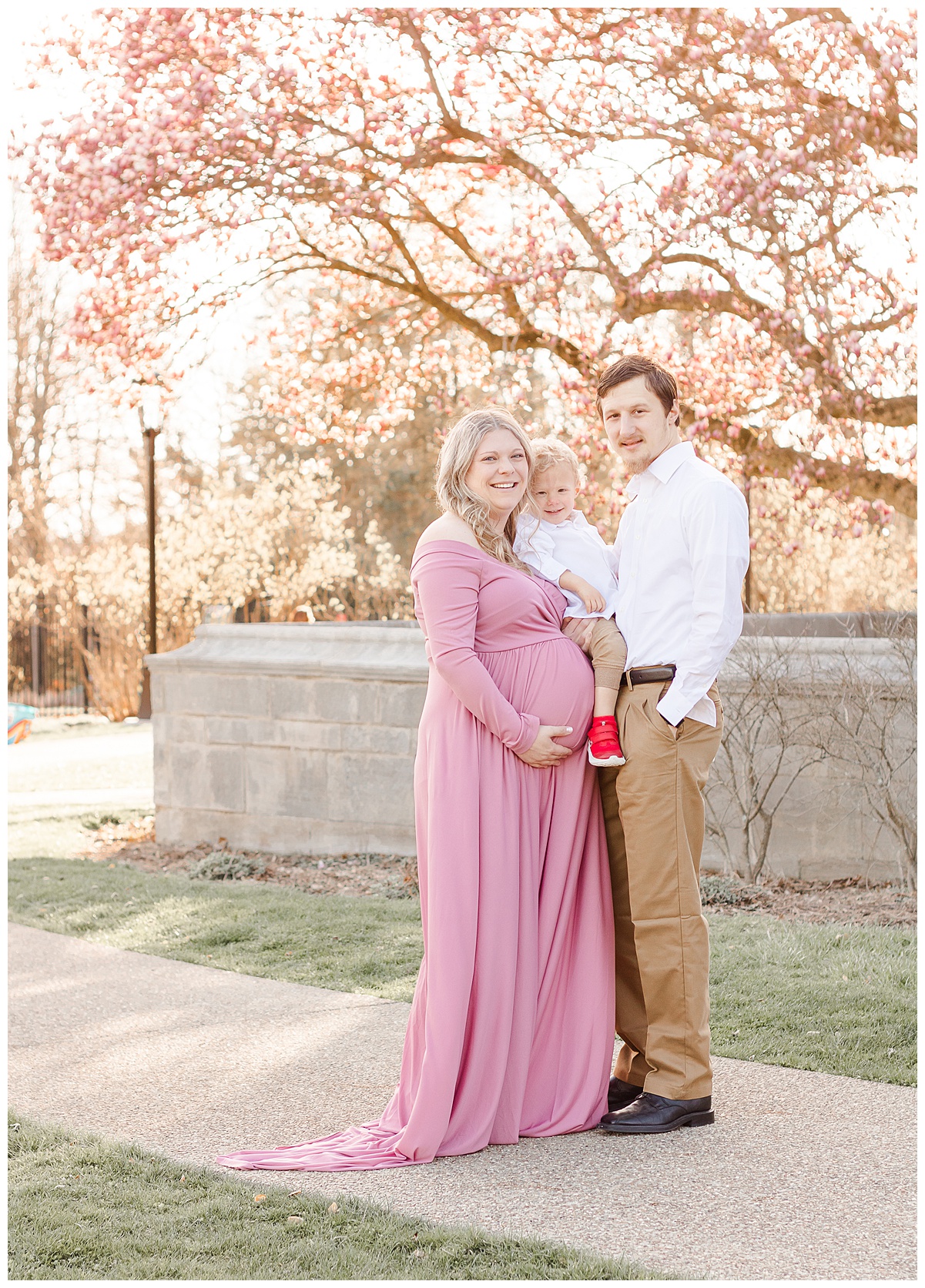 Mom and dad are holding their son during an outdoor family/maternity session in Pittsburgh, PA