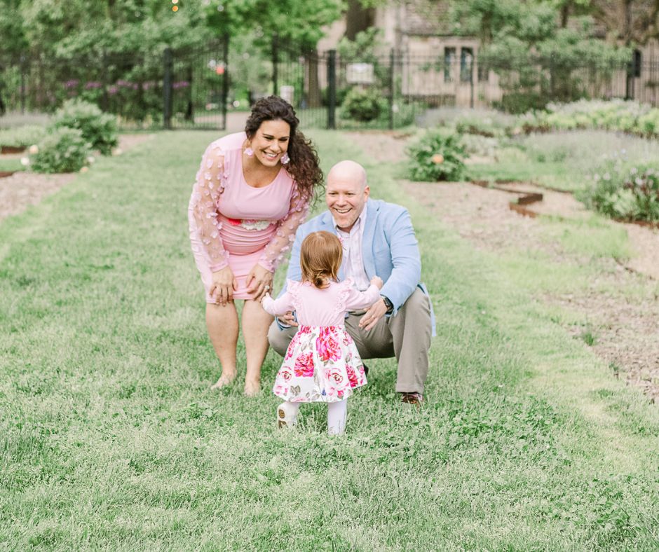 Mom and dad are waiting for their little girl to run towards them. This is taken during a outdoor maternity session in pittsburgh,pa.