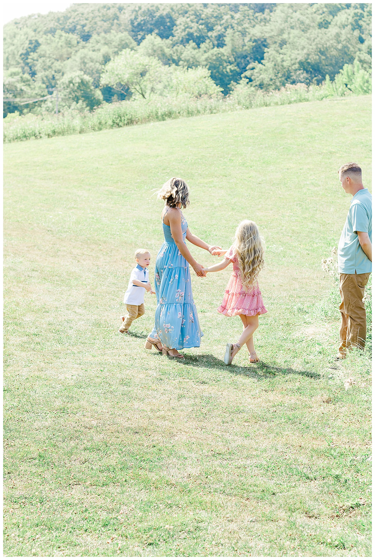 A family playing ring around the rosie during a photoshoot with a Wexford family photographer