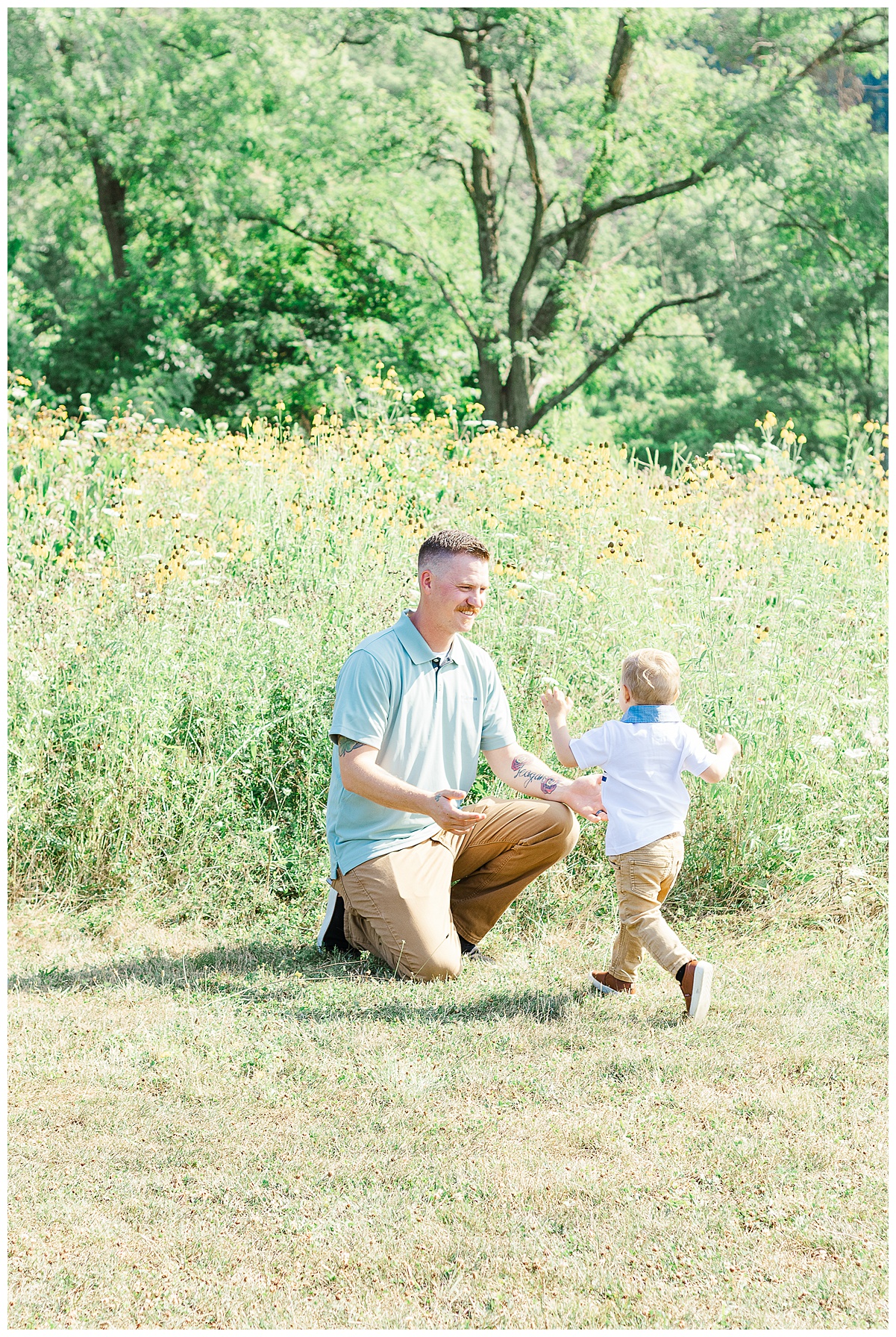 The dad is kneeling waiting for his to run to him.  This is taken during an outdoor family photoshoot in Pittsburgh