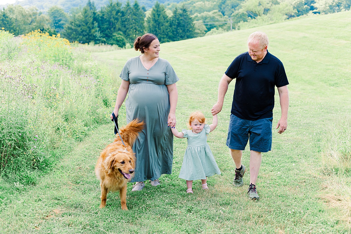 A family walk with their toddler, and dog during a photoshoot in pittsburgh
