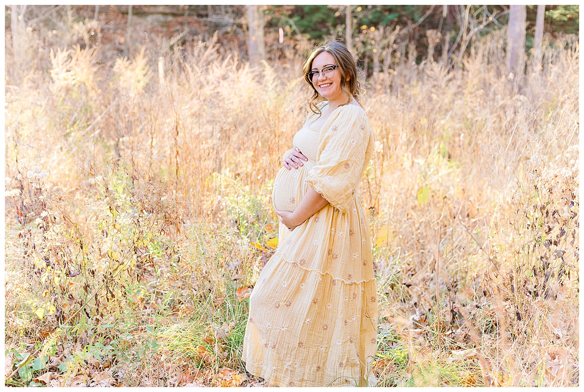 Mom holding her beautiful baby bump during a maternity session outdoors. Taken by a Pittsburgh baby and pregnancy photographer