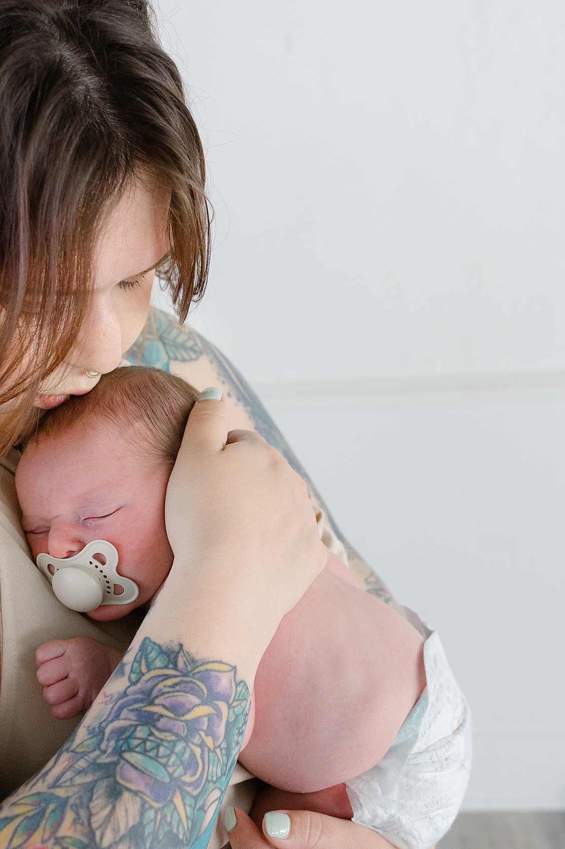 Mom giving baby boy kissing during their newborn session in Hampton