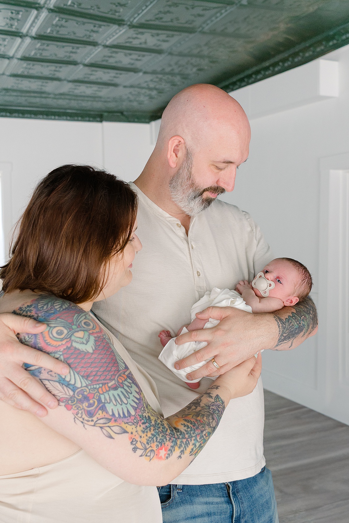 Mom and dad holding their baby boy in Hampton