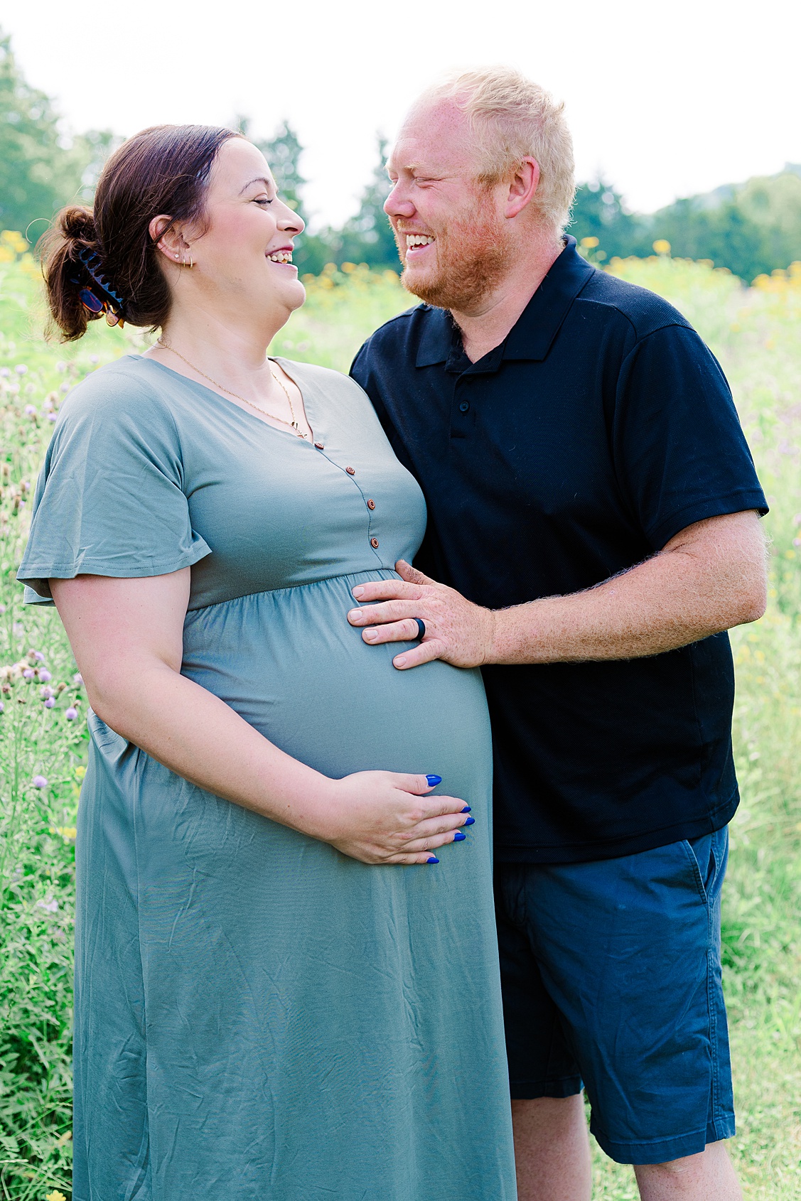 mom and dad laughing during an outdoor maternity photoshoot in Pittsburgh
