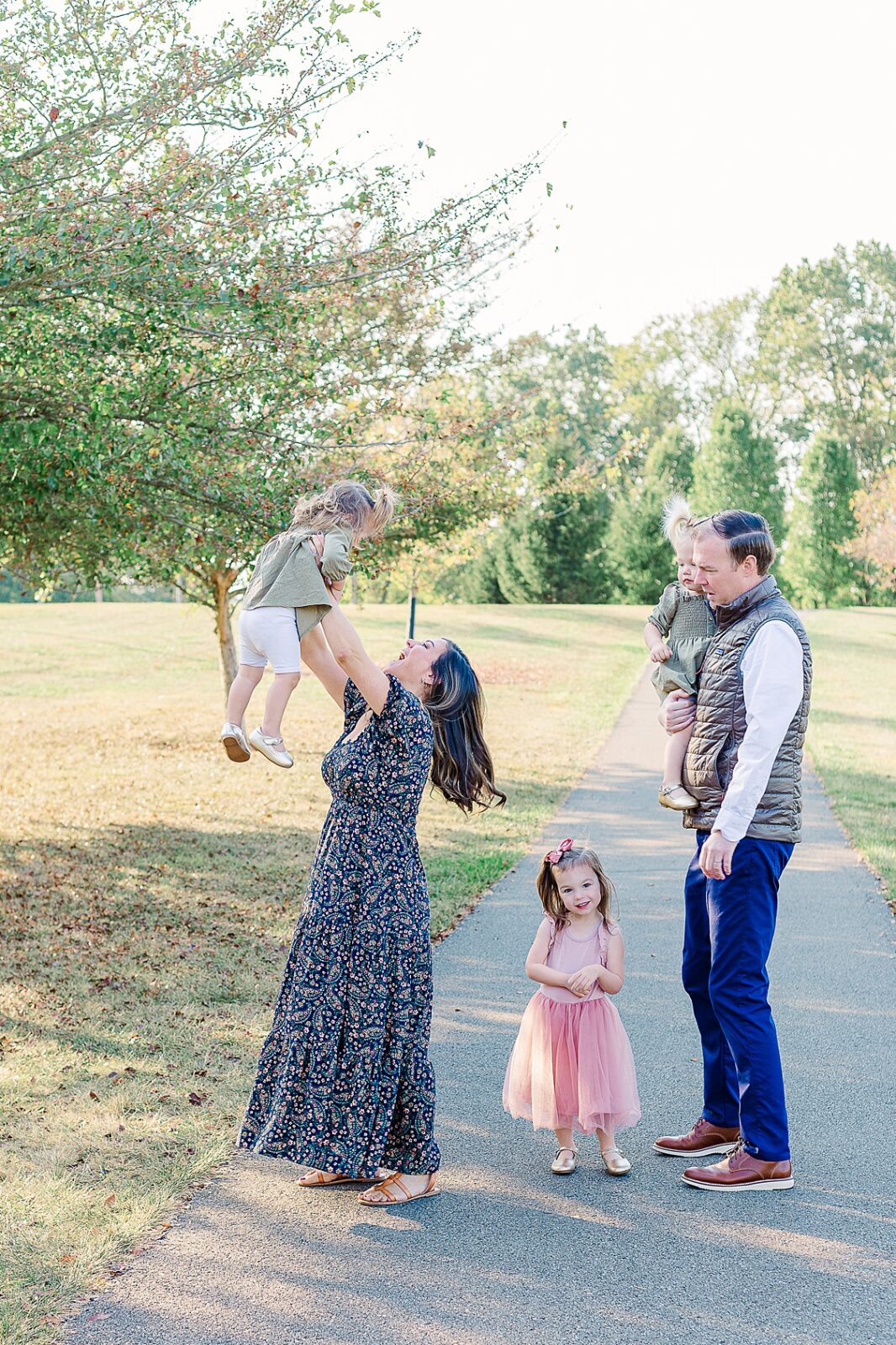 family having a fun moment during Pittsburgh holiday card shoot with young toddler