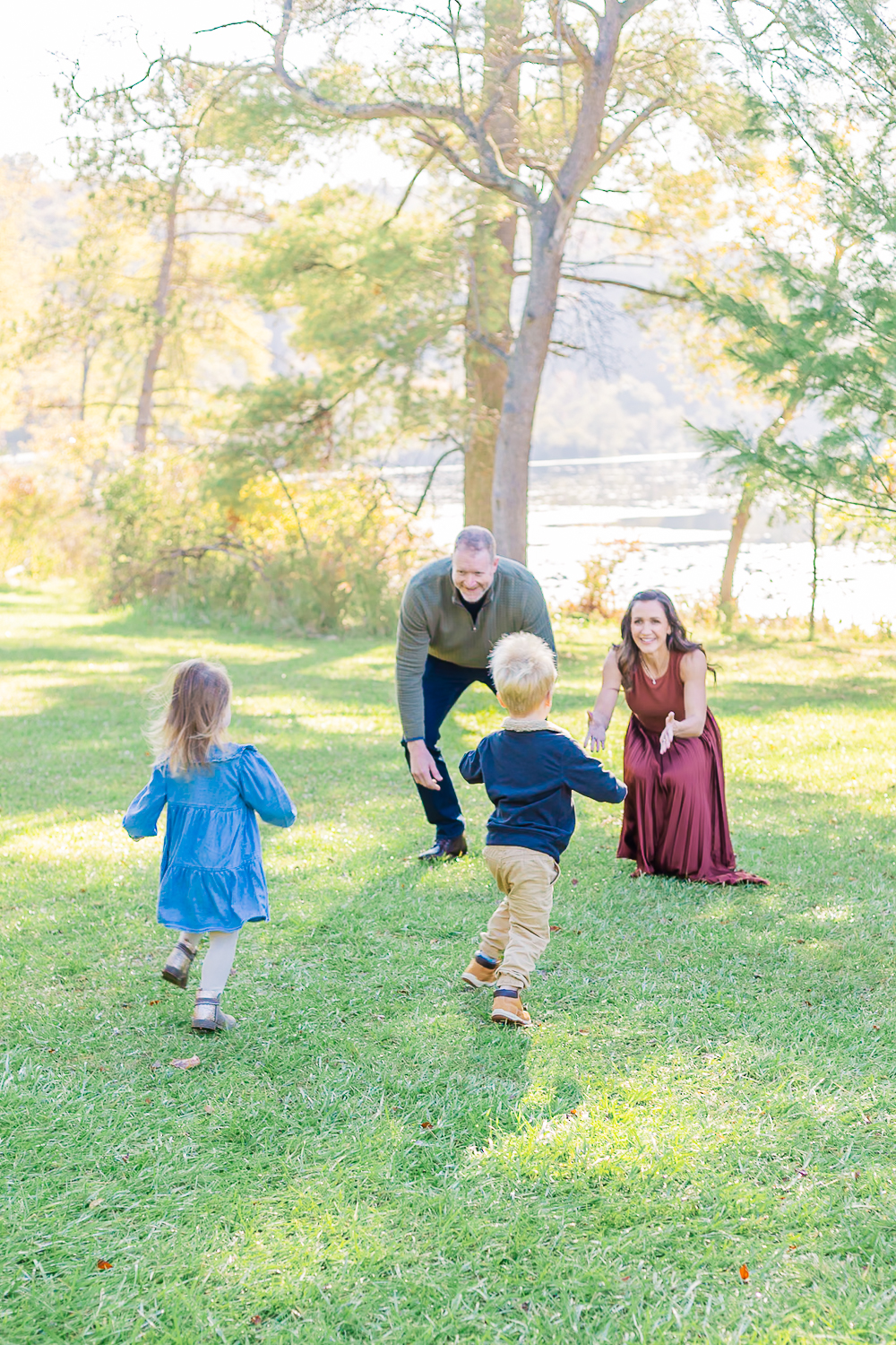 Kids running towards their mom and dad with the lake in the background during the family photos in Pittsburgh