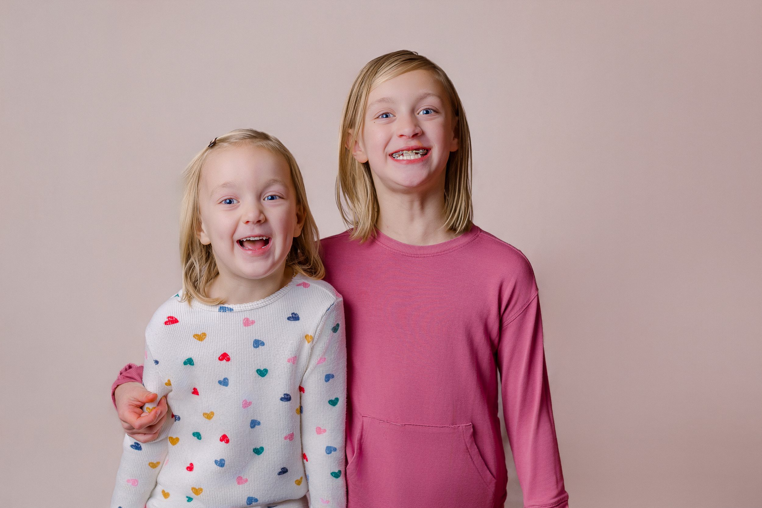 Playful siblings moving during a personality portrait session with a Pittsburgh children’s photographer