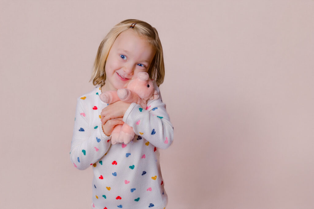 Capturing a sweet moment with a favorite stuffy during children's personality pictures session in Pittsburgh