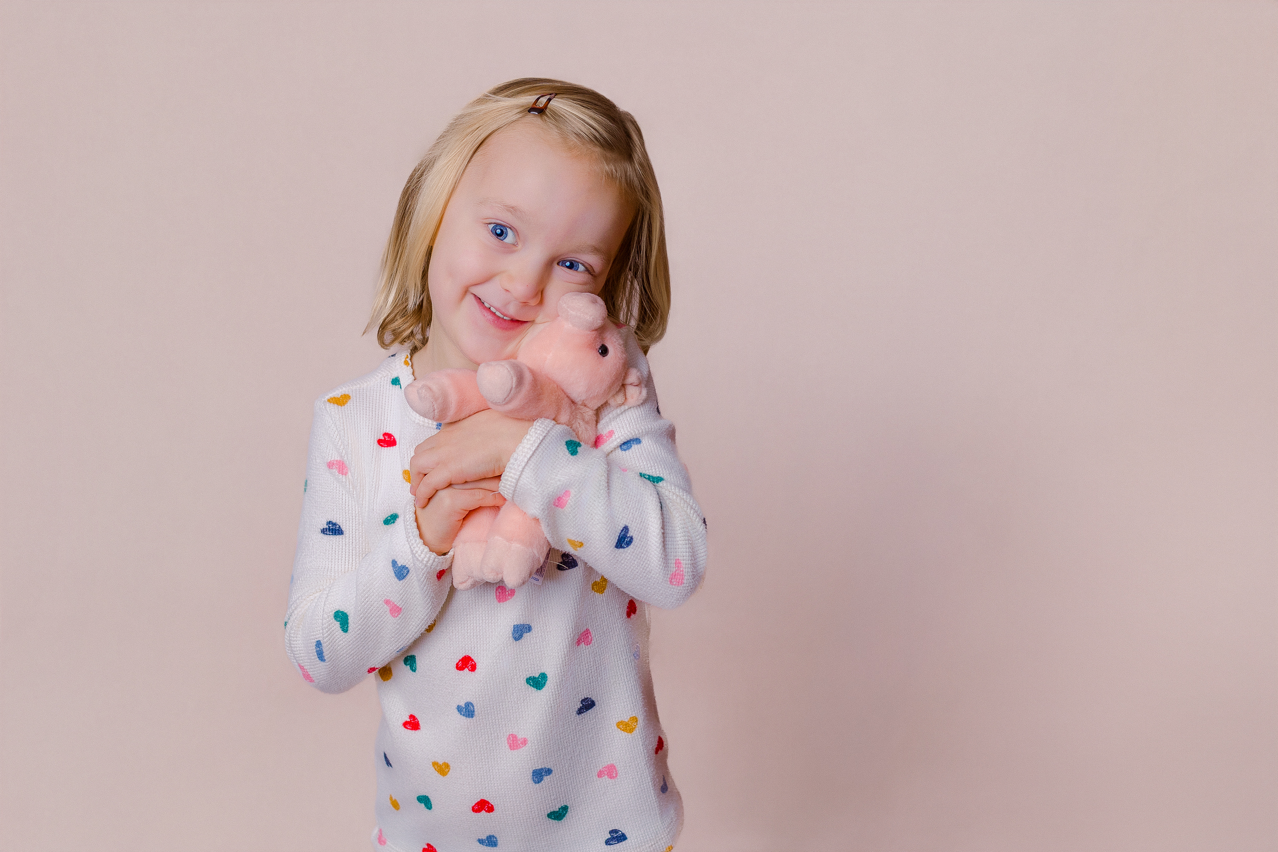 Child holding a favorite toy during a personality portrait session in Pittsburgh