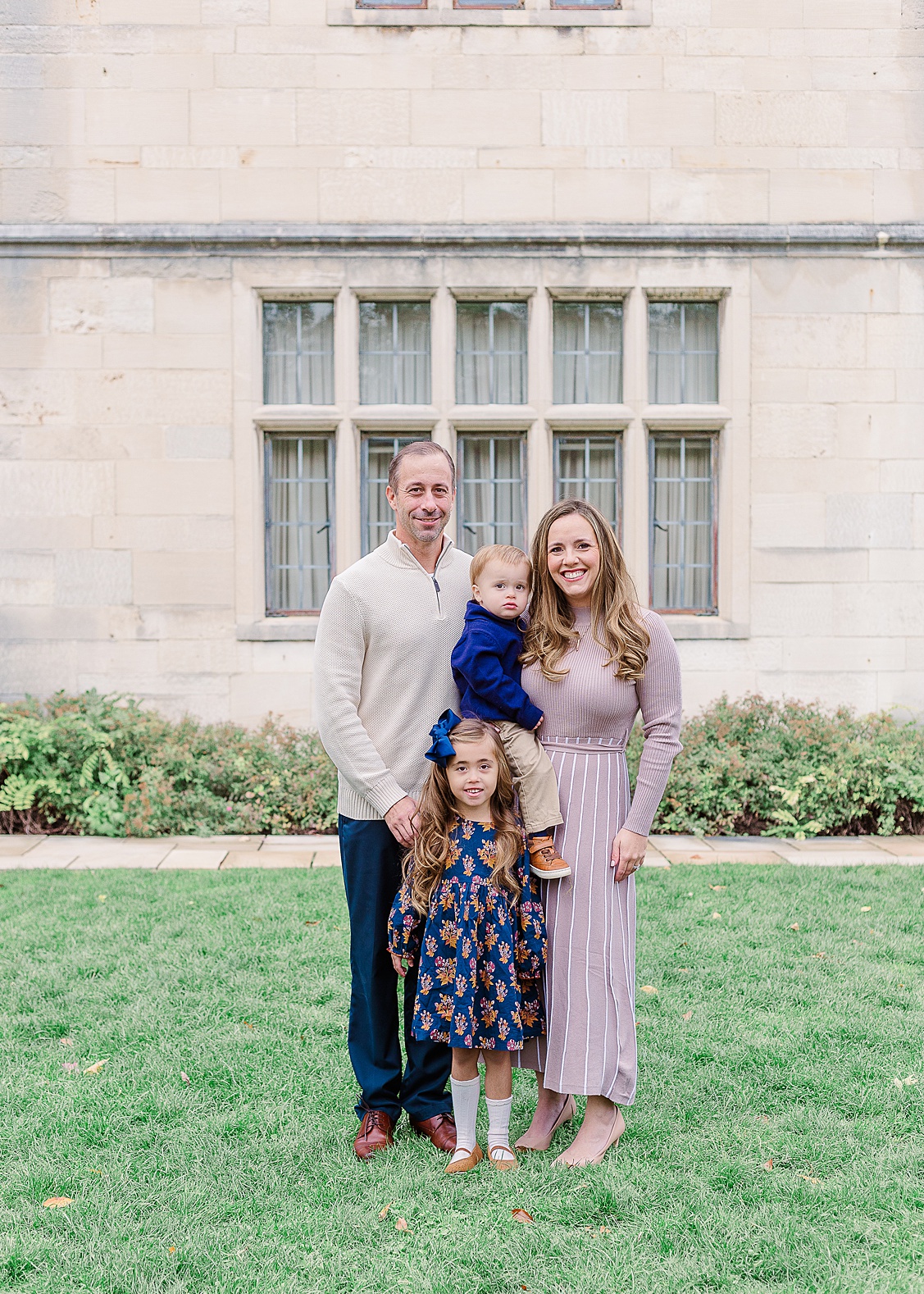 Family of four with parents, big sister, and little brother photographed outdoors at Hartwood Acres by a Pittsburgh photographer