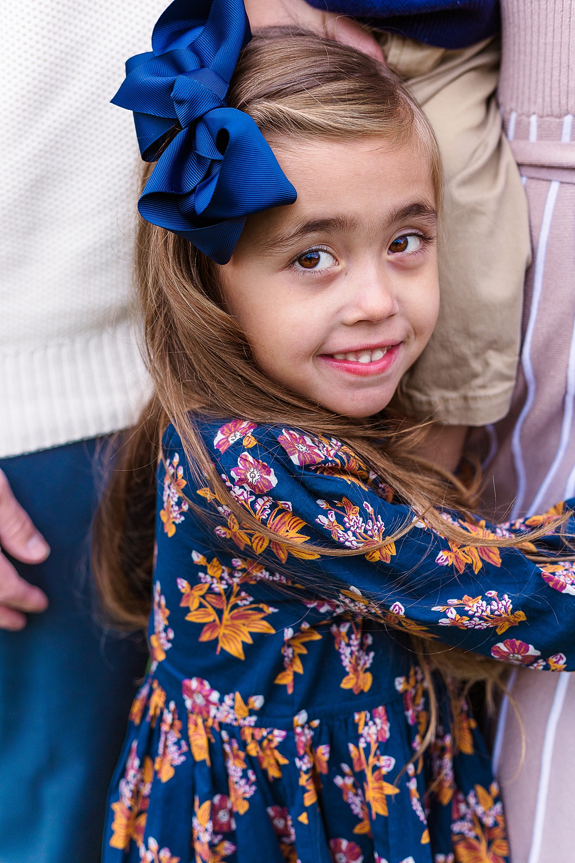 Candid child portrait of a daughter holding onto her mom photographed by a Pittsburgh photographer