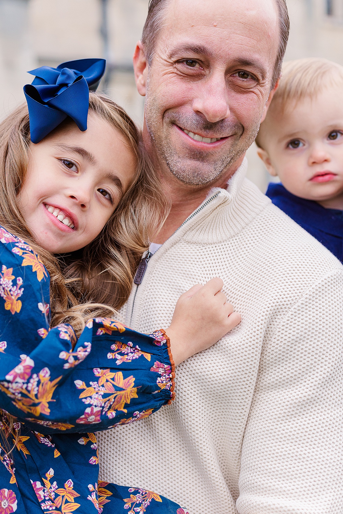 Natural family moment of dad laughing with his two children during an outdoor Pittsburgh photo session