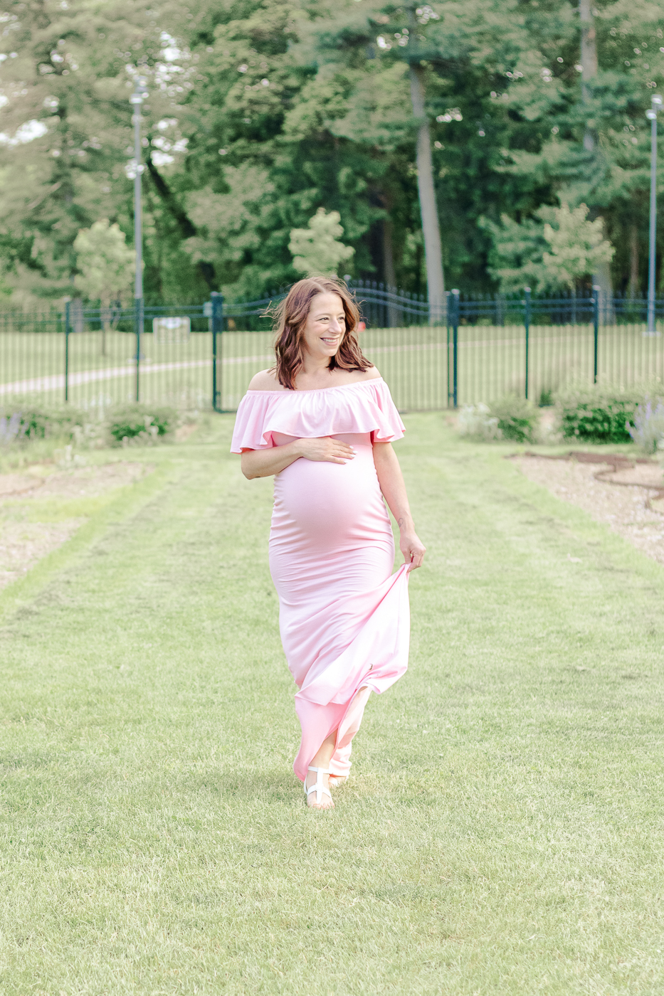 Mom to be walking during her maternity photo session taken by a local maternity photographer in pittsburgh.