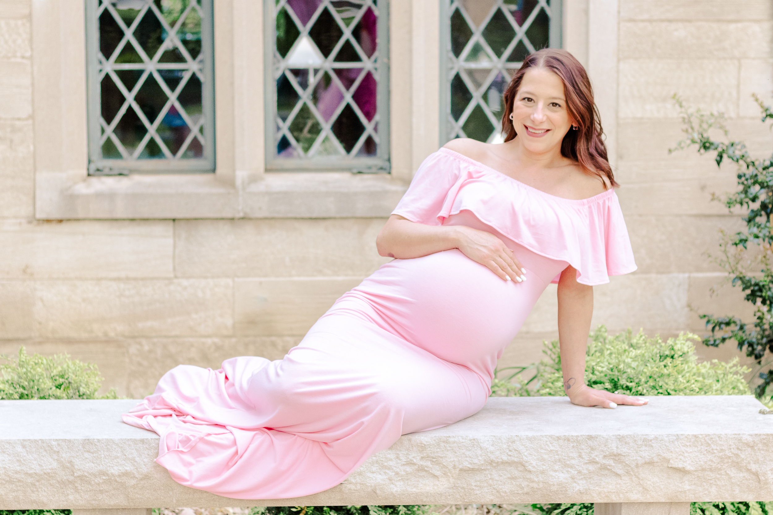 pregnant mom sitting on a bench being photographer by a local maternity photographer in Pittsburgh.