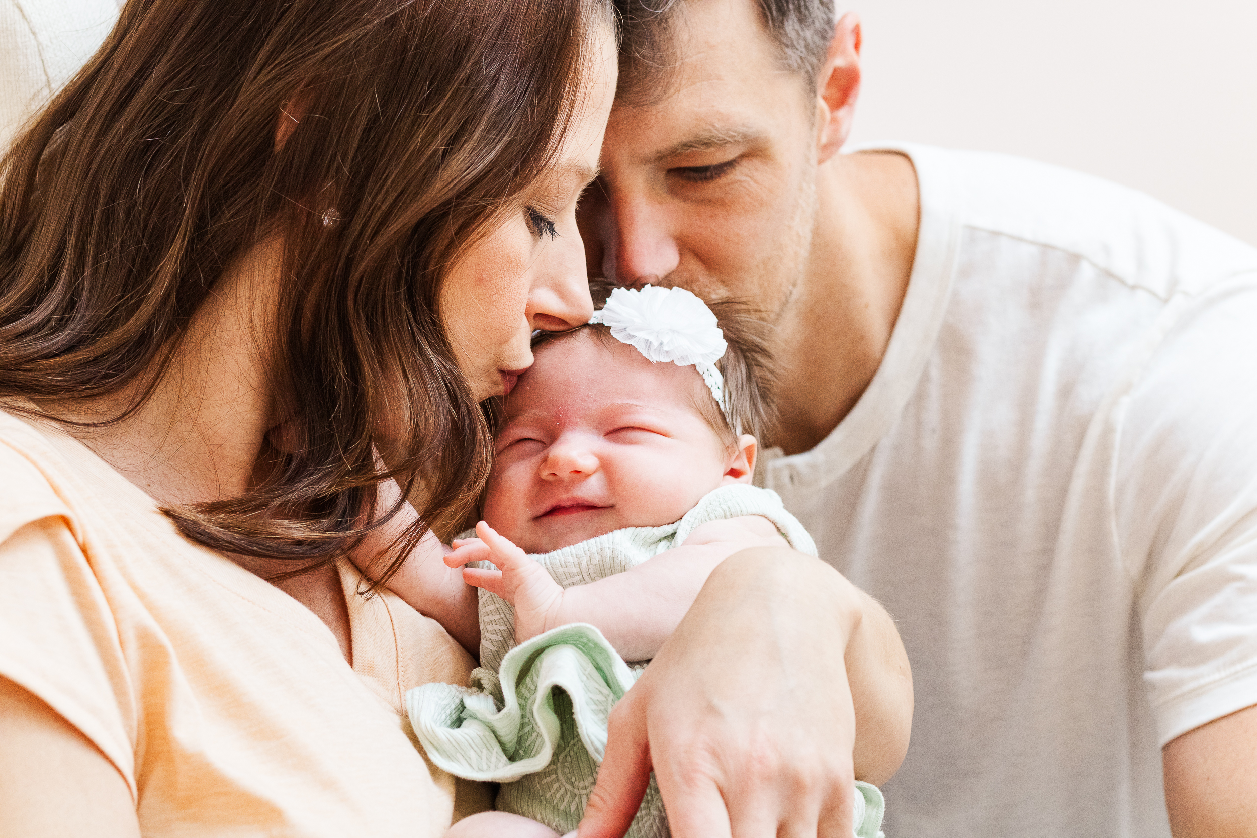 A sweet picture of mom, dad and baby girl that an in-home newborn photographer in Pittsburgh took.