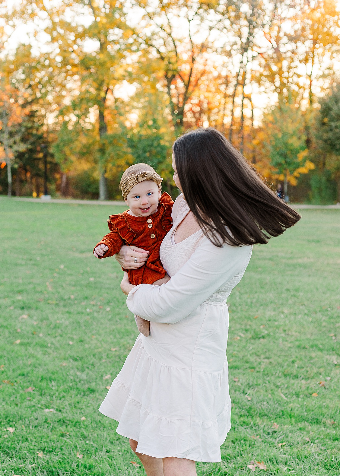 Mom is twirling around with her baby girl during g an outdoor session in Wexford.