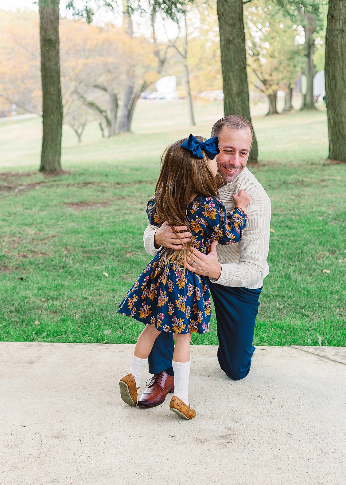 Daughter giving dad a kiss on the cheek during an outdoor Wexford Family Photography session.