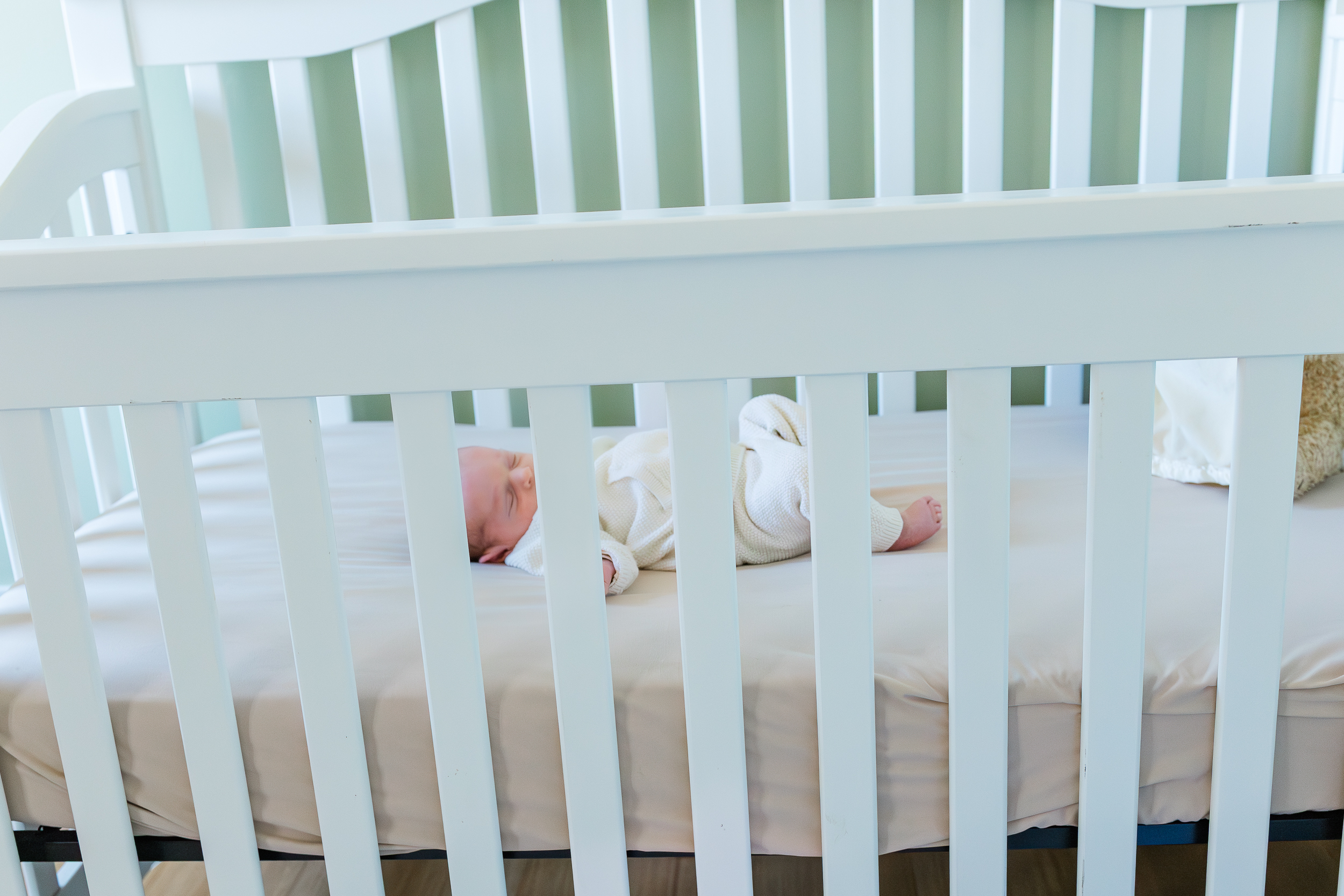 Sweet baby boy sleeping in his crib during his in home newborn session in Wexford, PA.