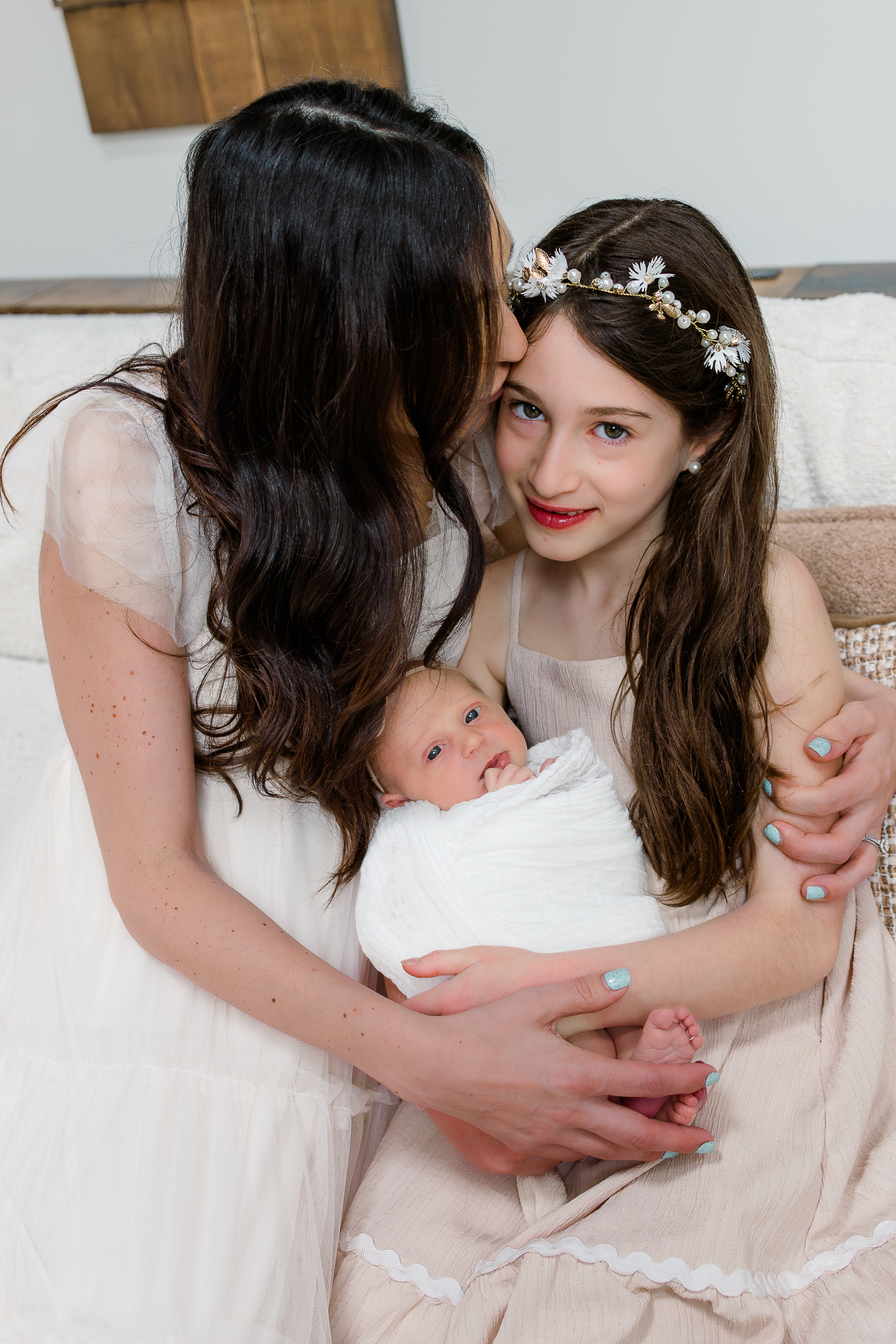 Finding the perfect newborn photographer isn't hard but you need to know what questions to ask. This is a picture of mom, her older daughter and her youngest daughter taken by a Pittsburgh Newborn Photographer