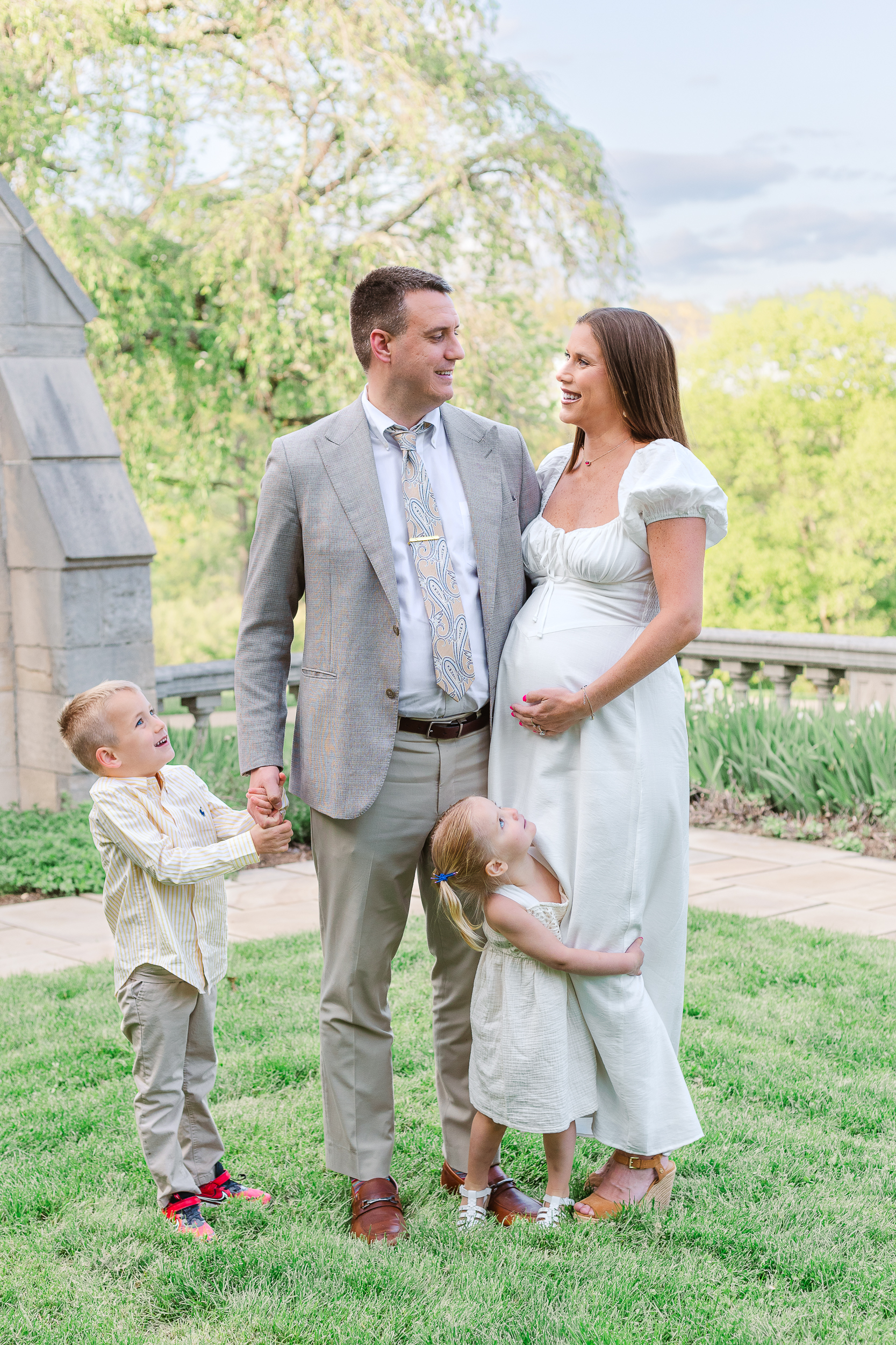 Mom and dad sharing a quiet look while their son and daughter hold their hands during a Wexford maternity photoshoot