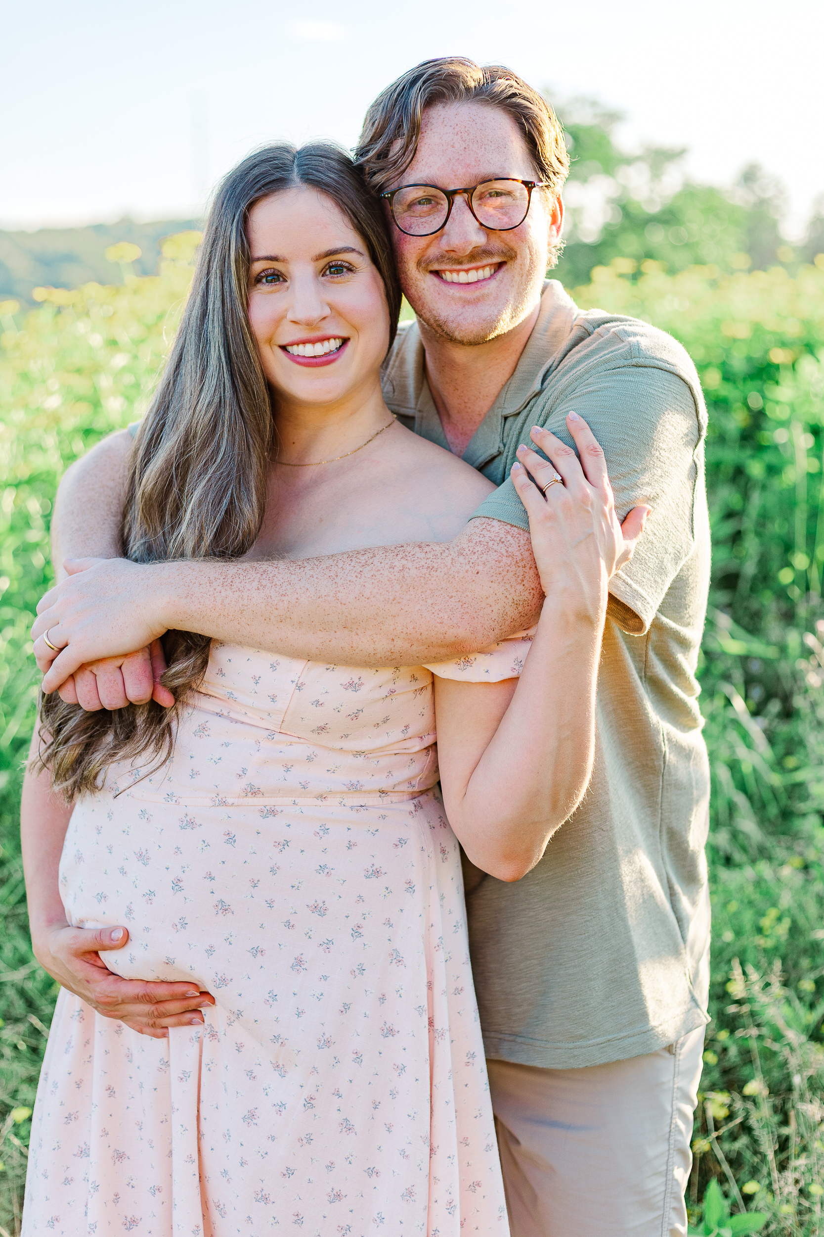 A Pittsburgh Maternity Photographer took this photo of mom and dad together. Both looking at the camera and smiling.