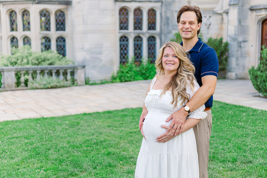 Mom and Dad are standing together during their maternity photography session in Pittsburgh in front of Hartwood Acres Mansion. 